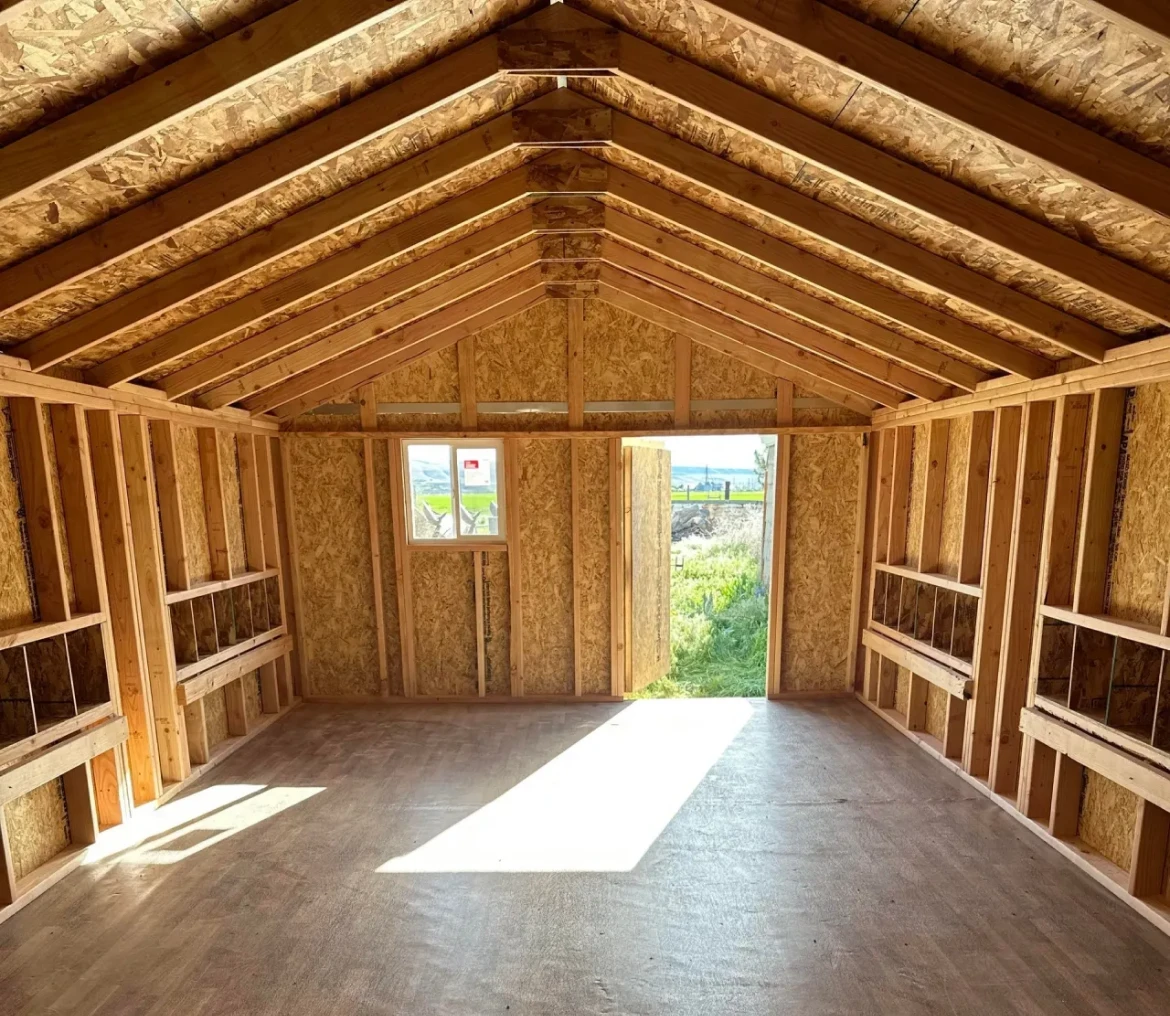 Wooden shed interior with open door.