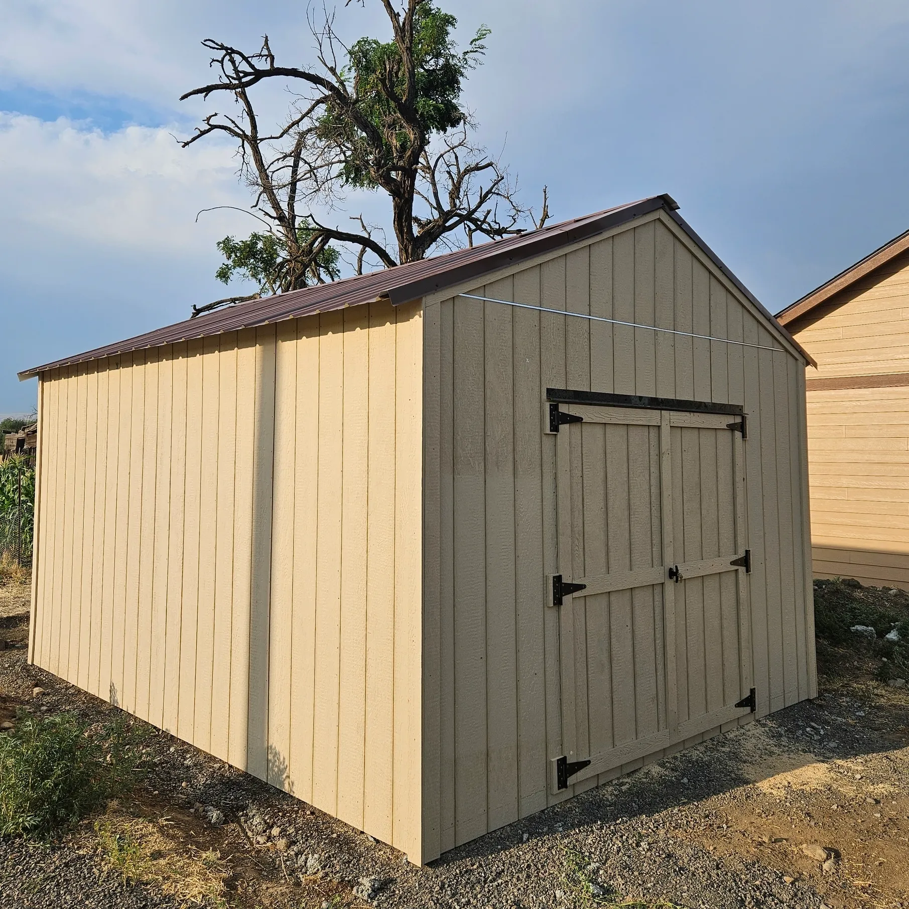 Wooden shed with a tin roof.
